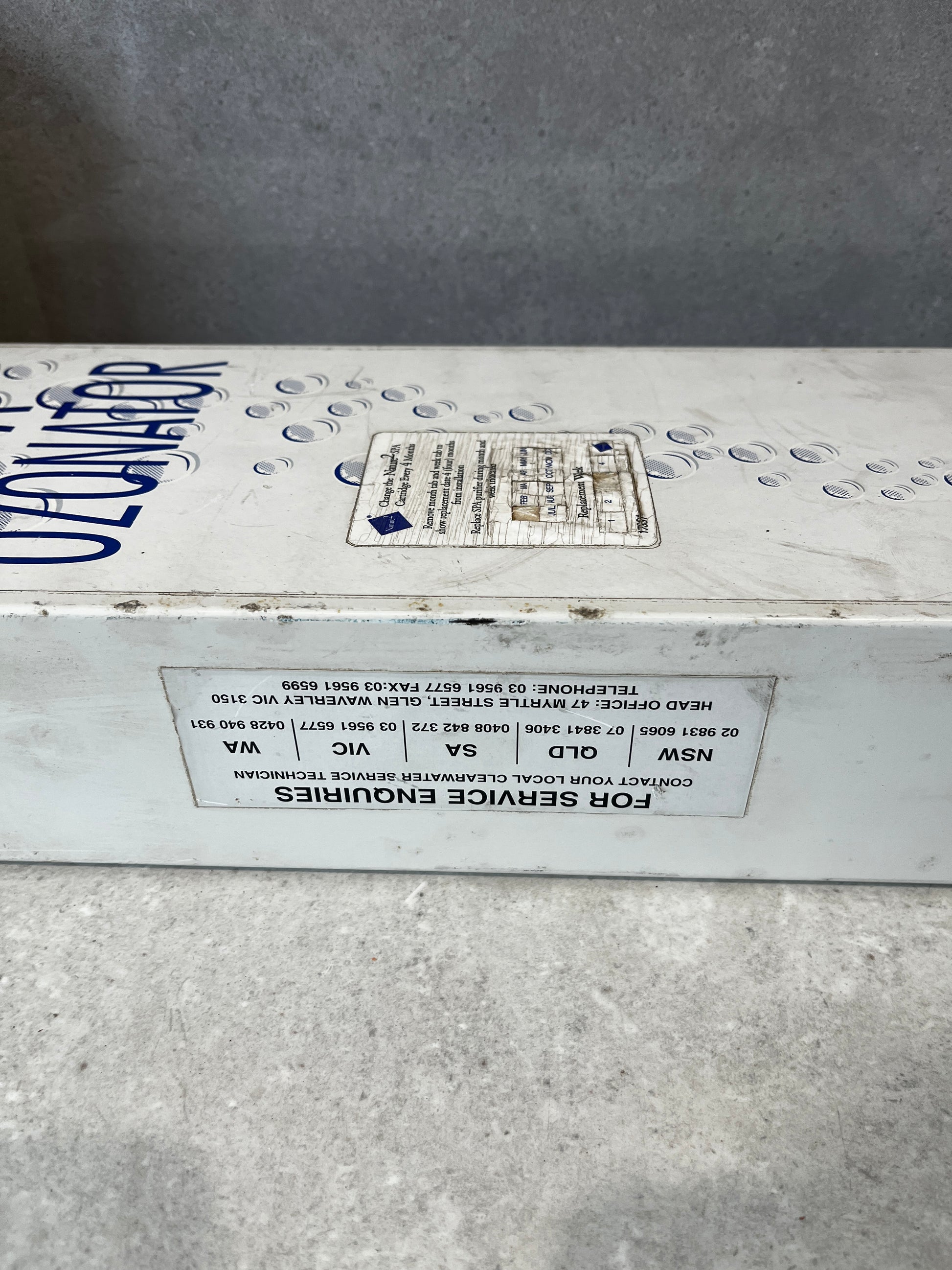Closeup of Clearwater spa ozonator service label and company details
