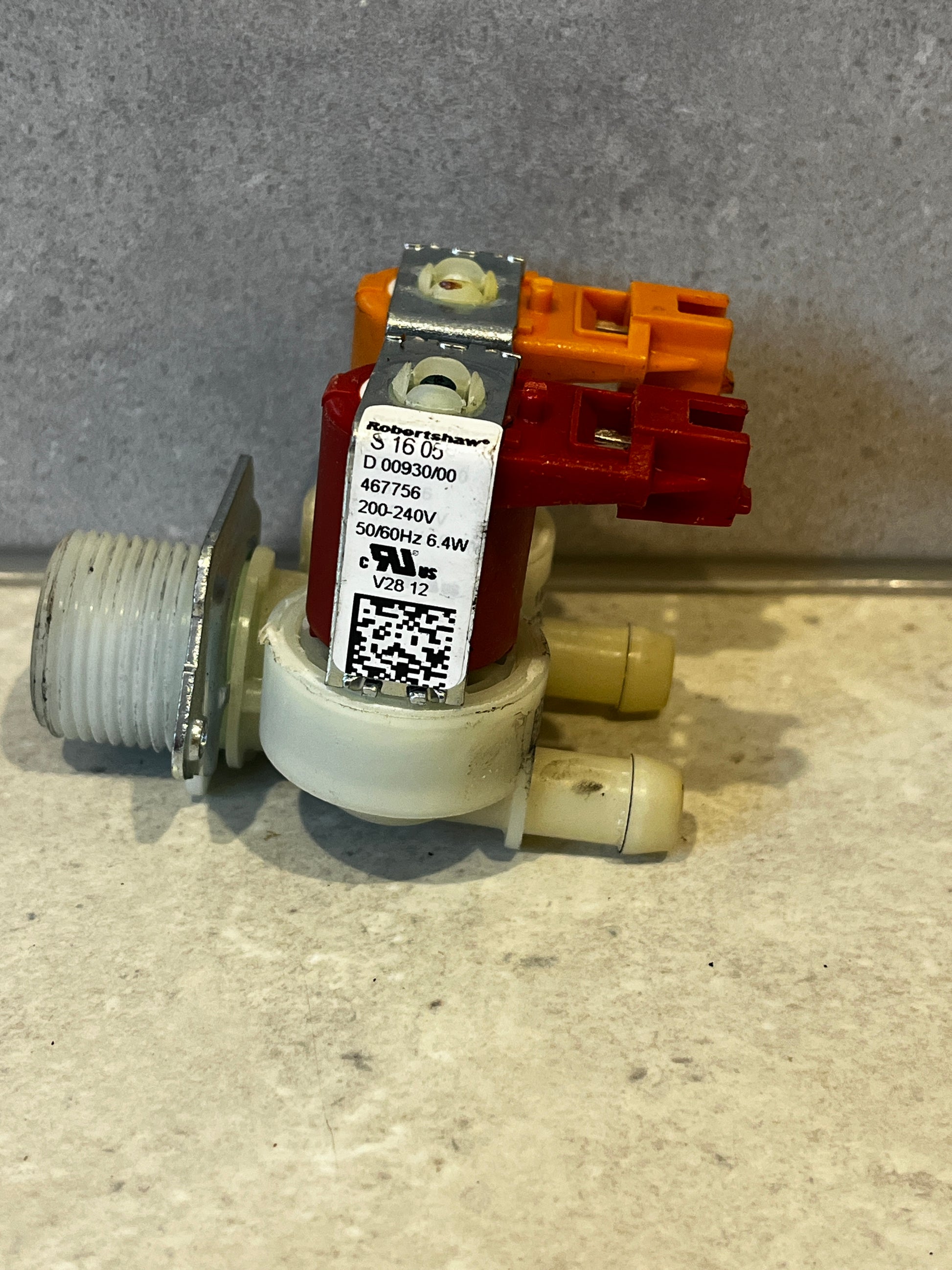 Side view of dual inlet solenoid water valve showing voltage label and connectors