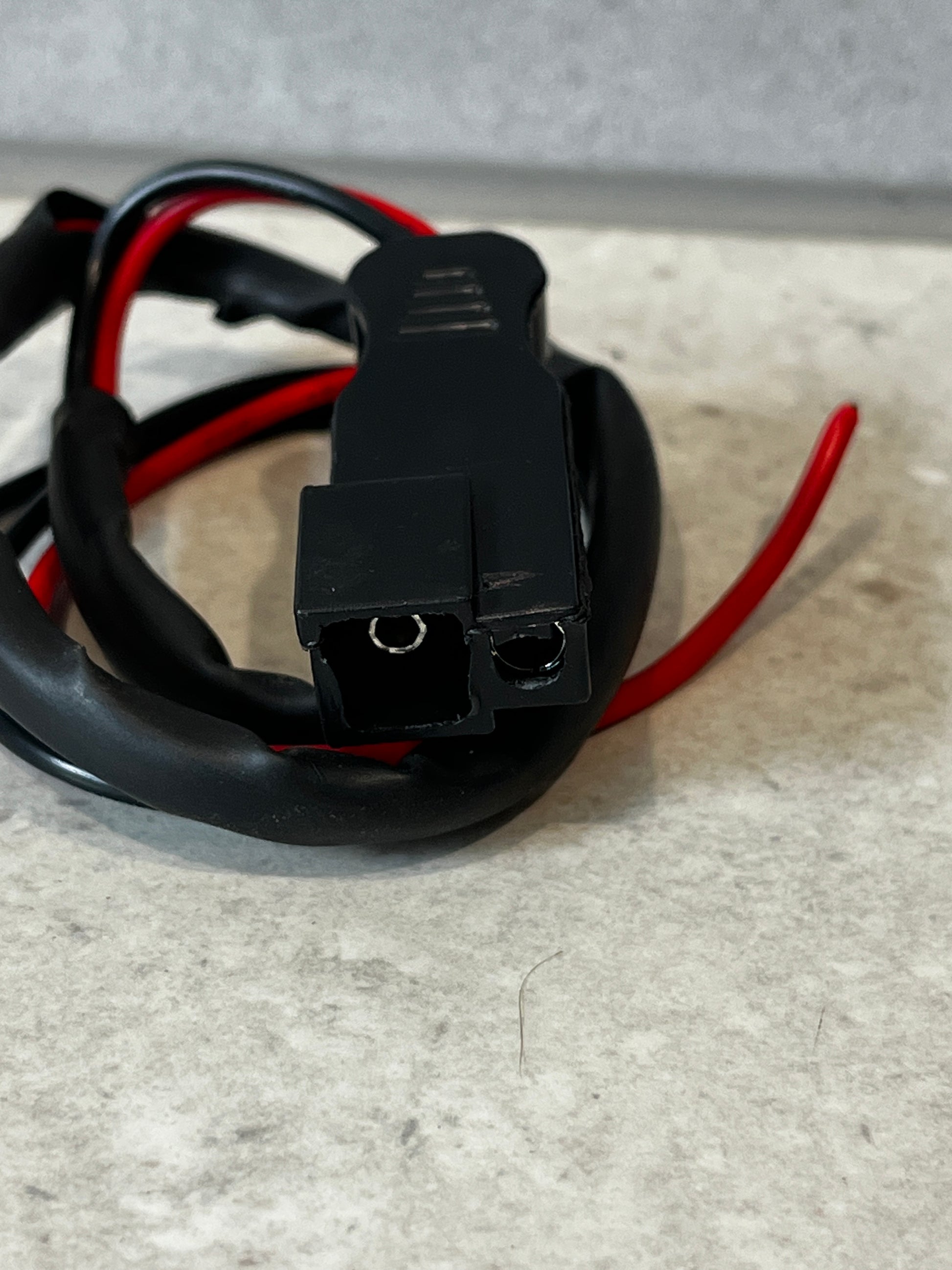 Close-up of black SAE connector with red and black wires
