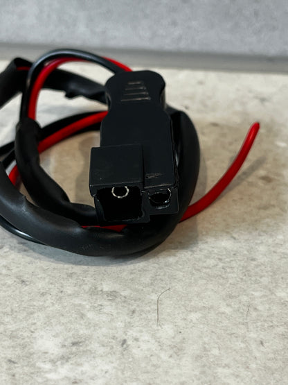 Close-up of black SAE connector with red and black wires
