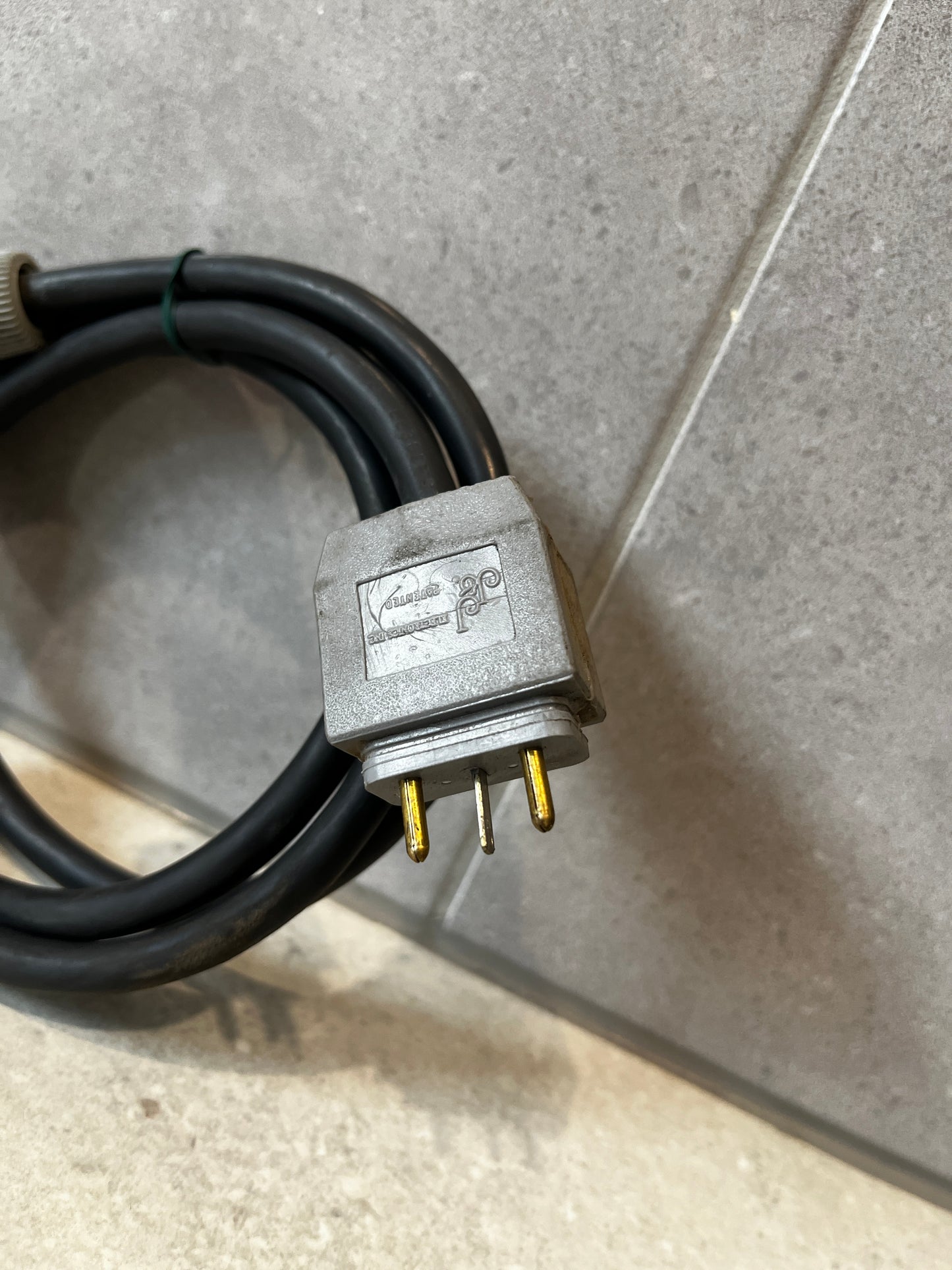 Close-up of three-prong Indu Electric plug on power cable