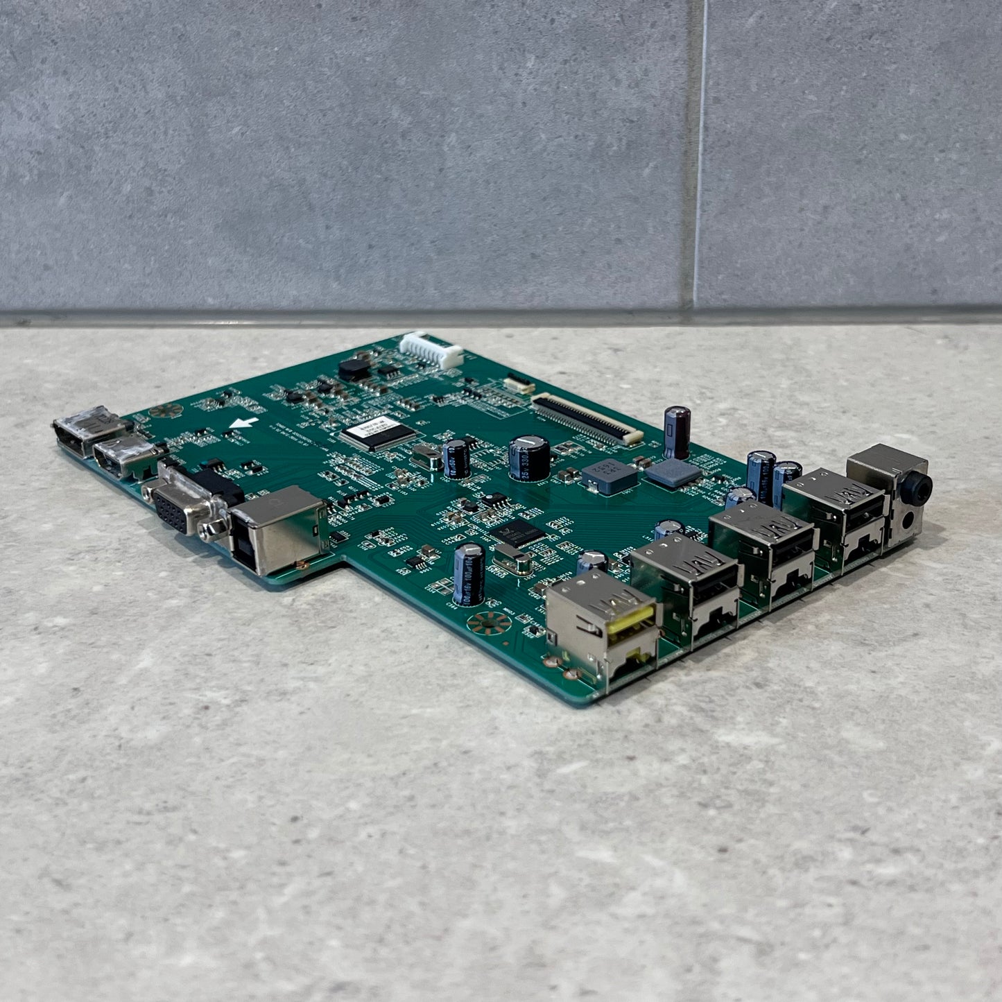 Angled side view of Lenovo T24i-10 T2465 monitor main board showing port layout