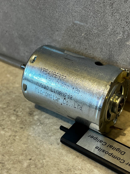 Close-up angled view of a metal electric DC motor showing wiring terminals