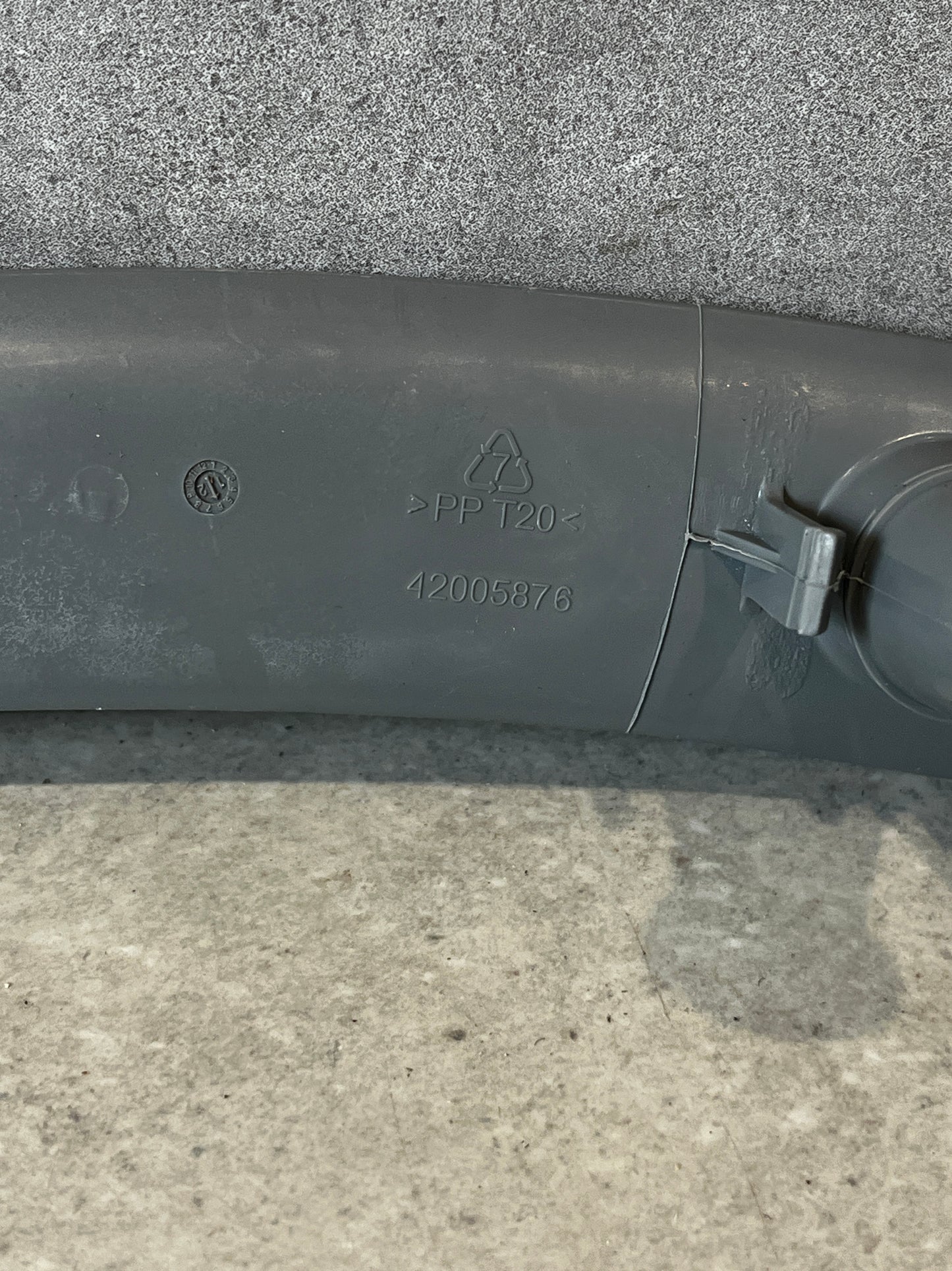 Closeup of dishwasher spray arm showing polypropylene material code