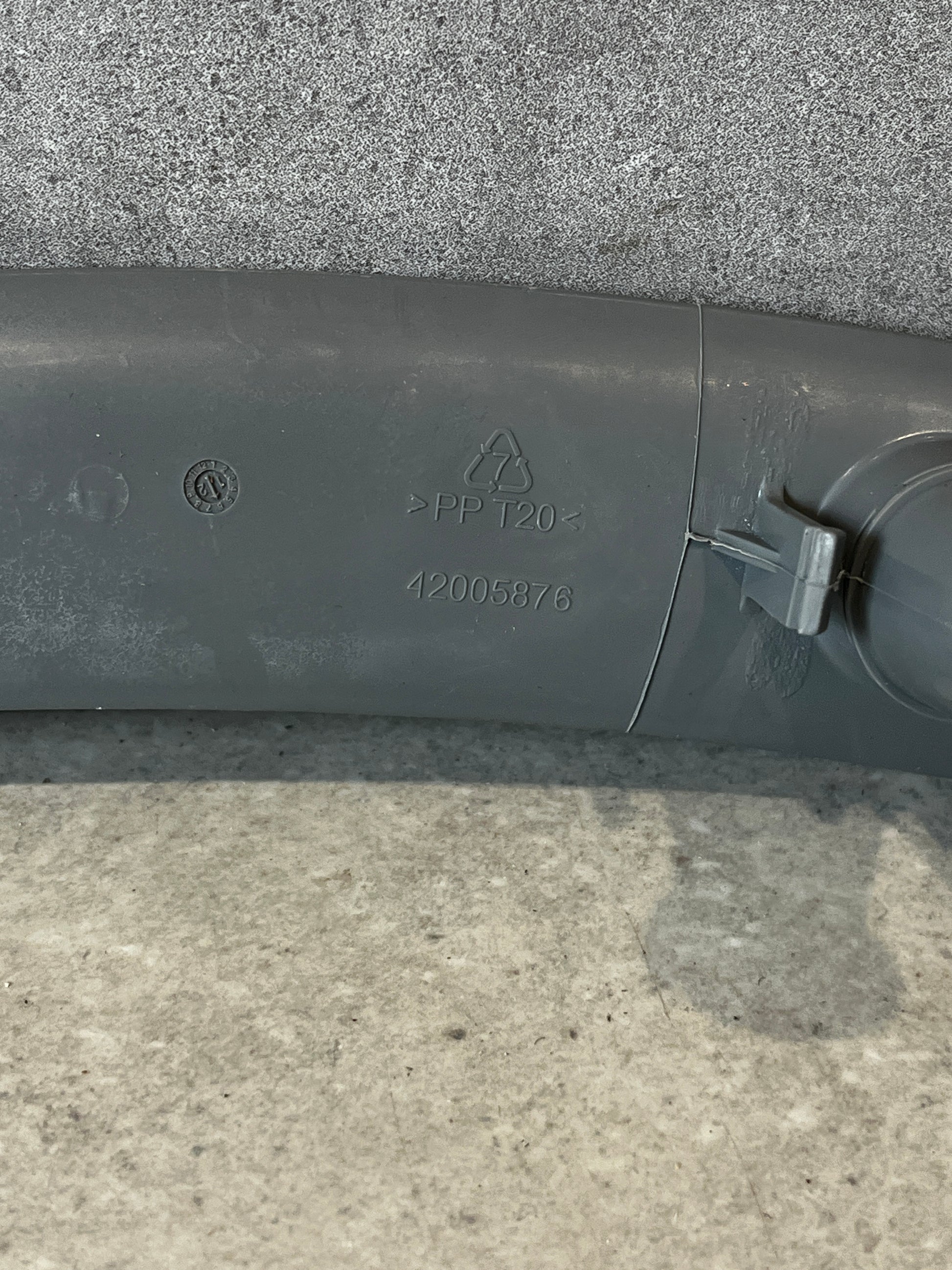 Closeup of dishwasher spray arm showing polypropylene material code