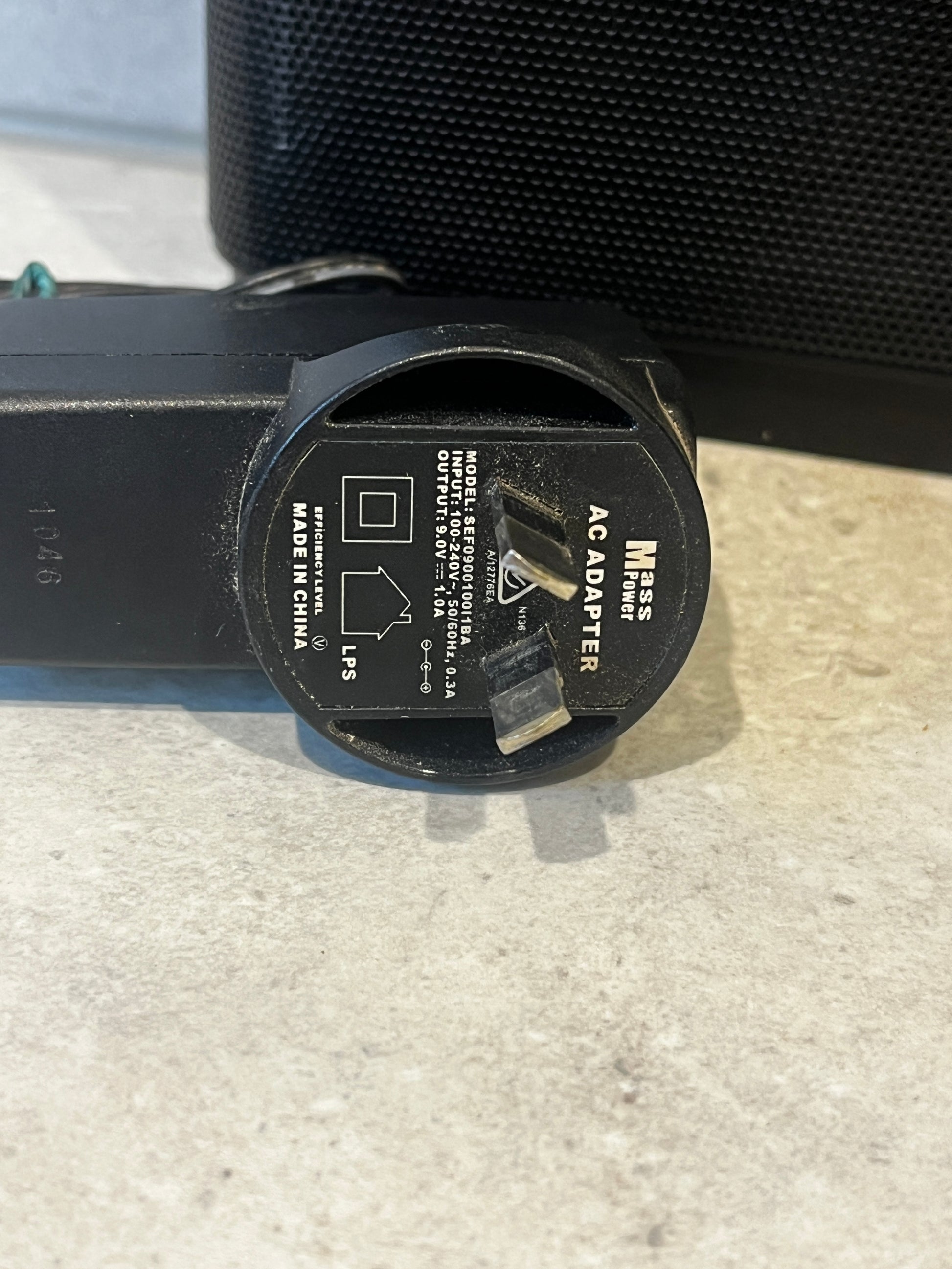 Close-up of Mass Power AC adapter plug and label