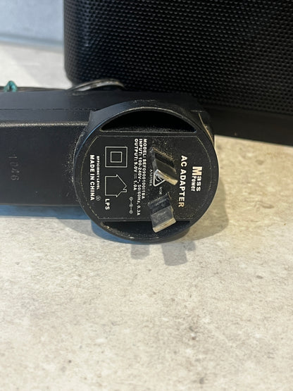 Close-up of Mass Power AC adapter plug and label