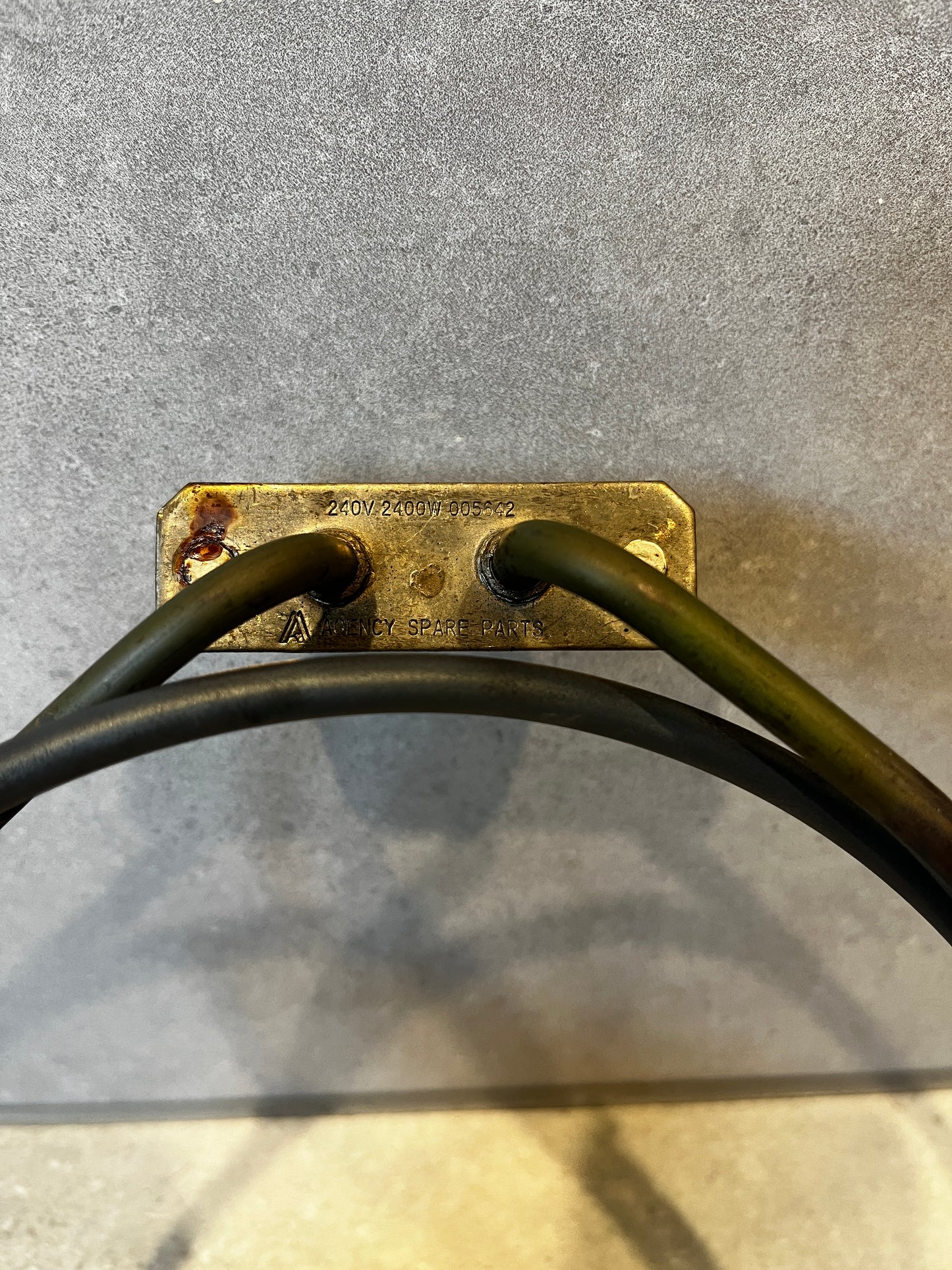 Close-up of metal base plate of the oven heating element showing stamped voltage 240V 2400W