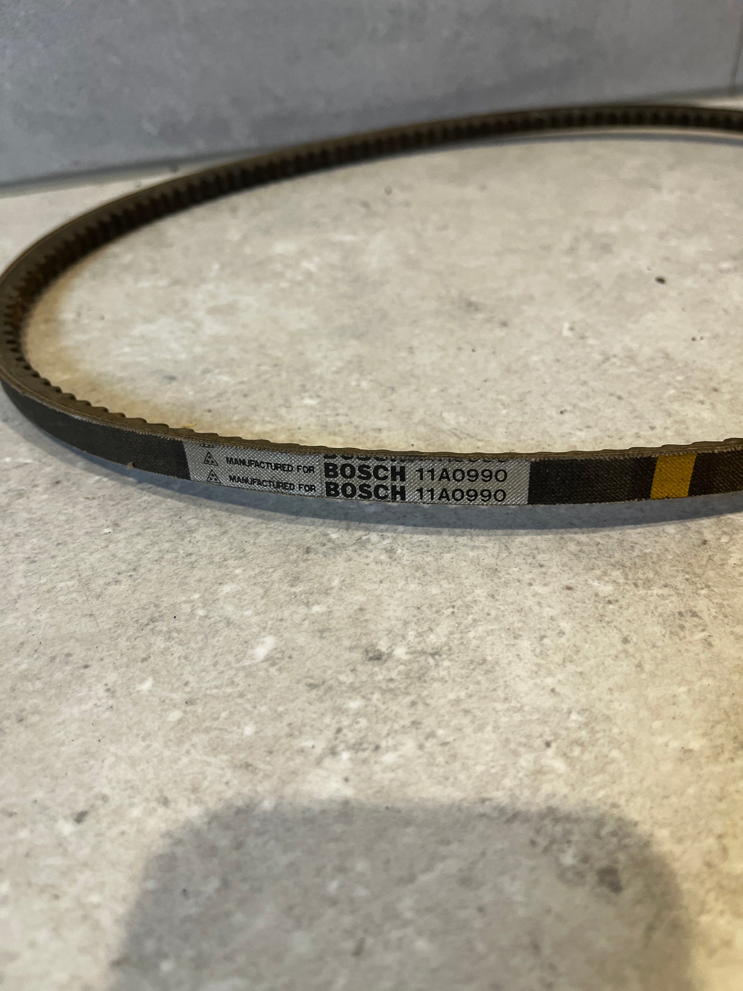 Close-up of Bosch Drive Belt 11A0990 showing label and details