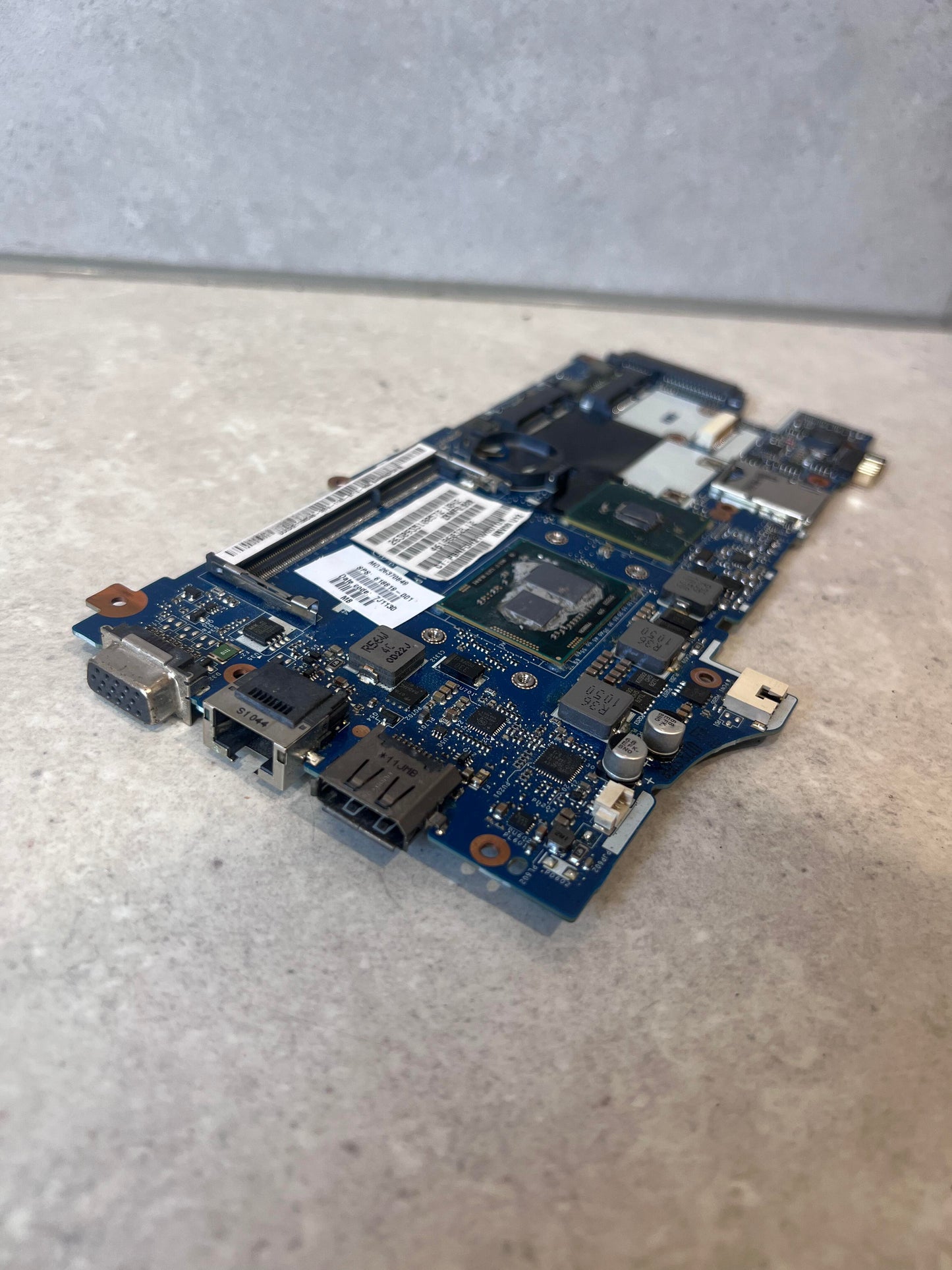 Angled side view highlighting ports and chipset of Lenovo LA-6161P motherboard