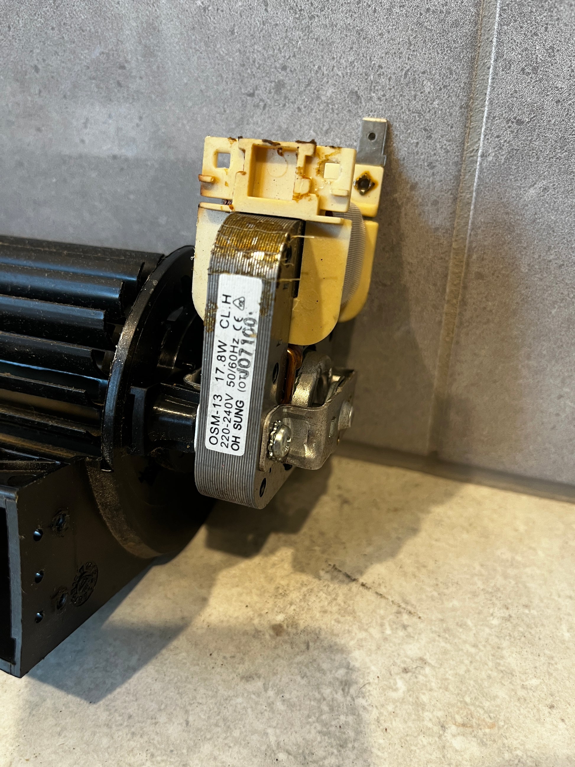 Close-up of ventilation blower motor showing technical label and electrical components