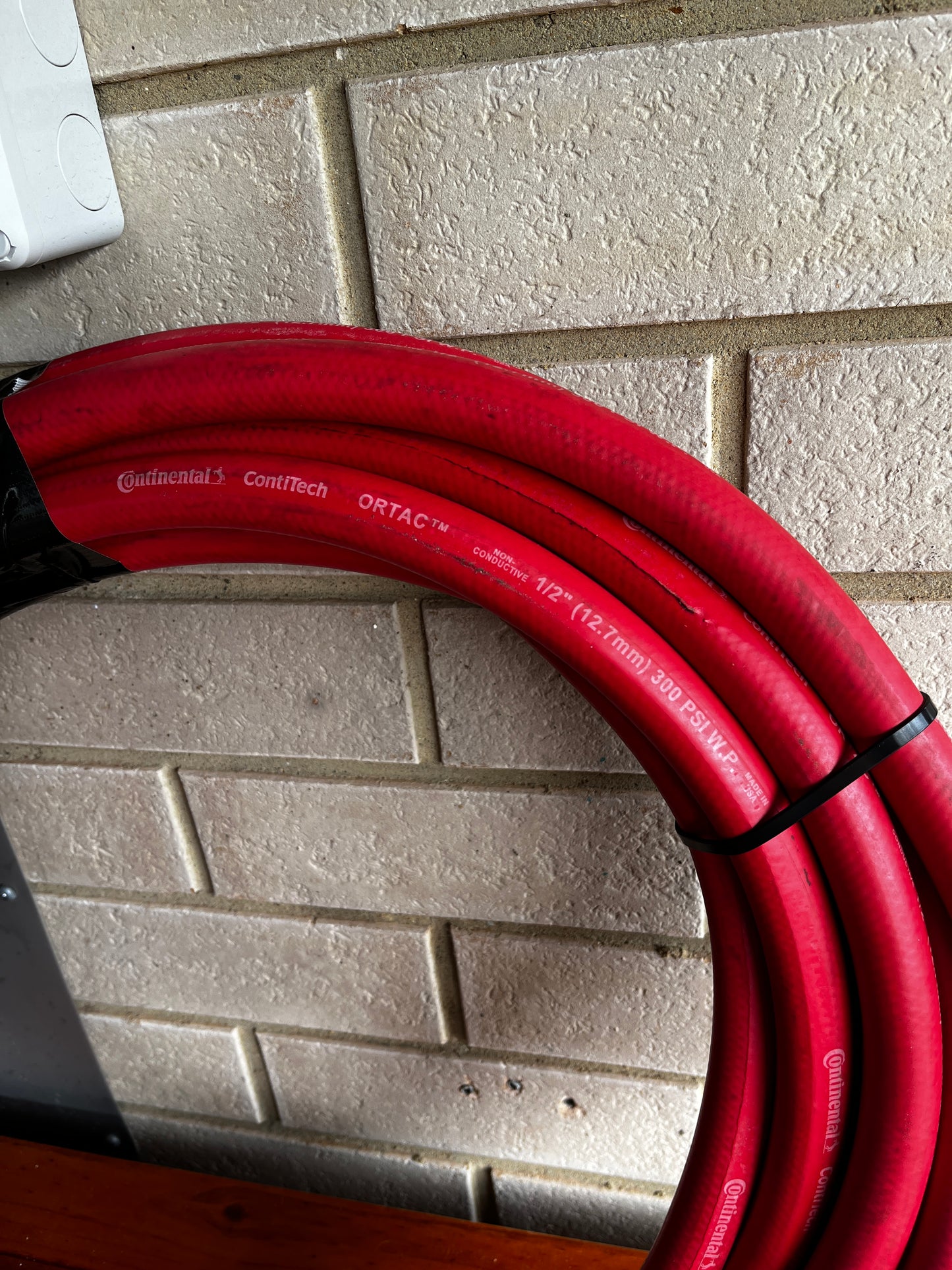 Close-up of Continental ContiTech ORTAC 1/2 inch industrial hose with specifications