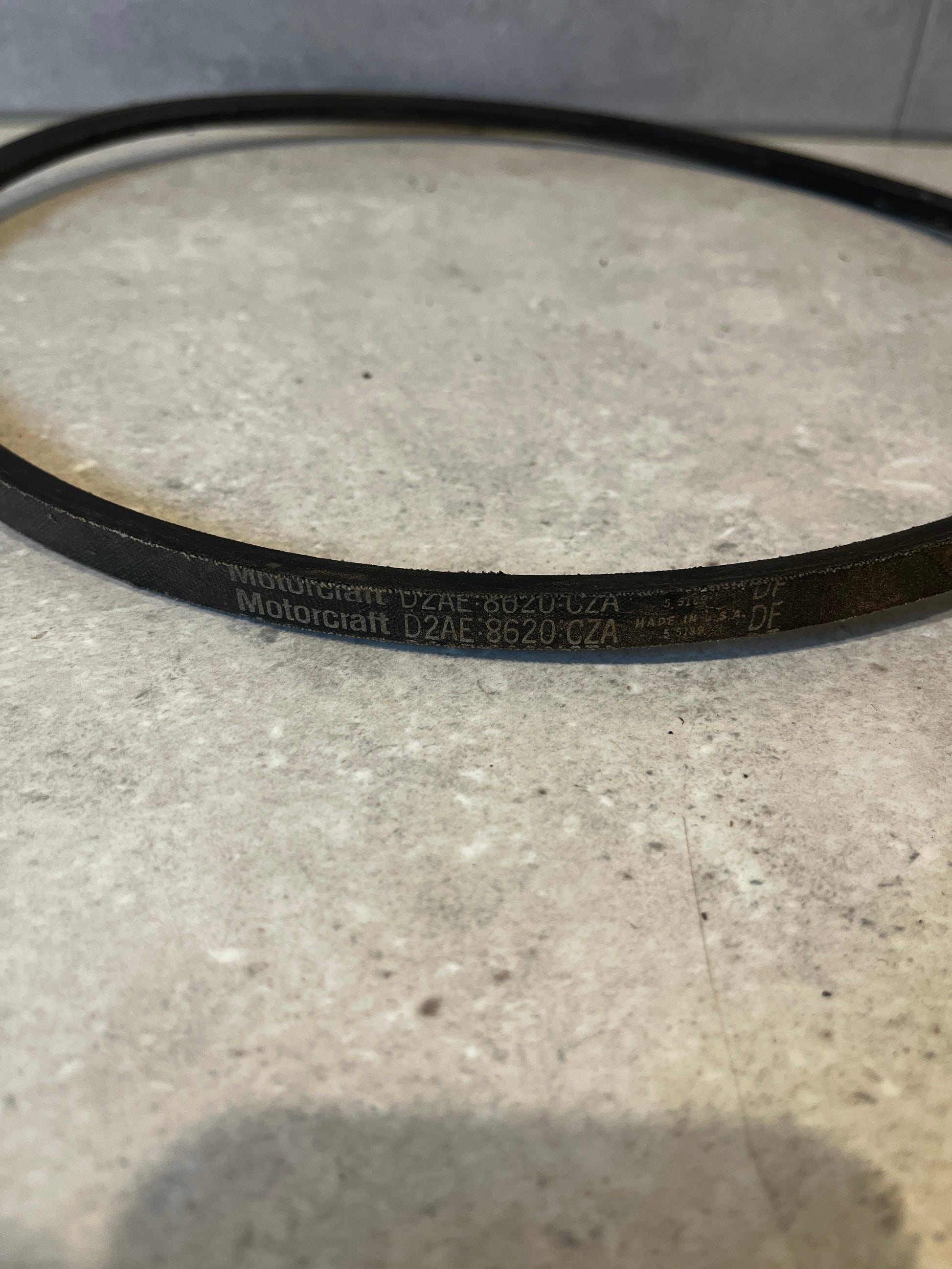 Close-up of Motorcraft D2AE-8620-CZA engine drive belt showing branding and part number