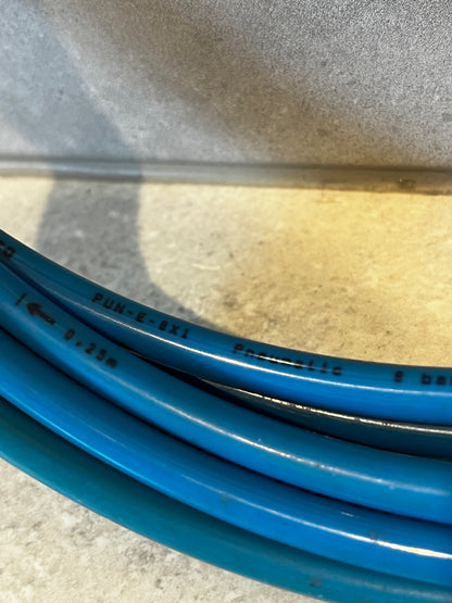 Close-up of blue polyurethane pneumatic hose surface with printed specifications