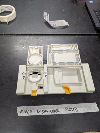 Open view showing compartments of Miele G1023 dishwasher dual detergent dispenser