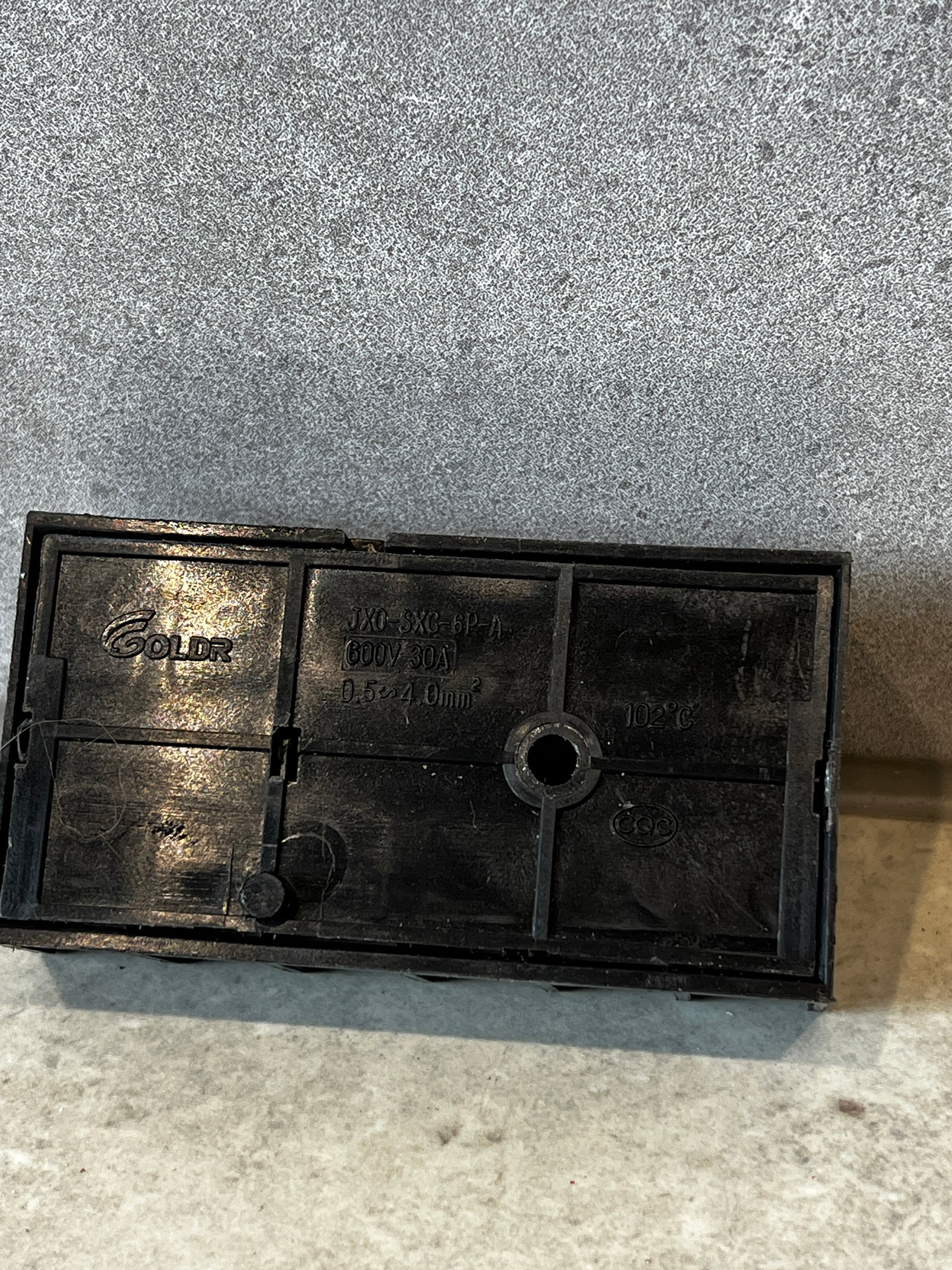 Back view of 6-pole terminal block showing specifications and manufacturer markings