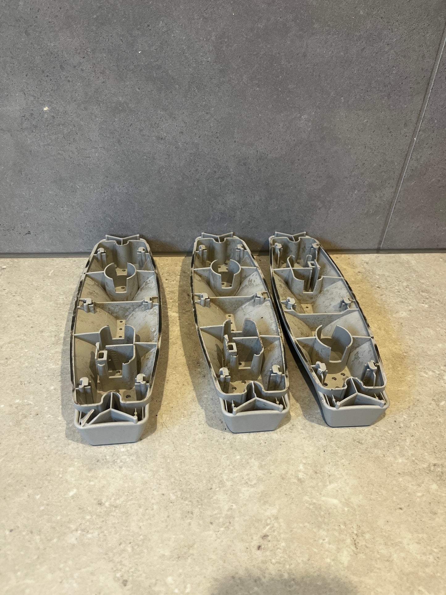 Underside view showing the attachment points of three dishwasher rack roller assemblies