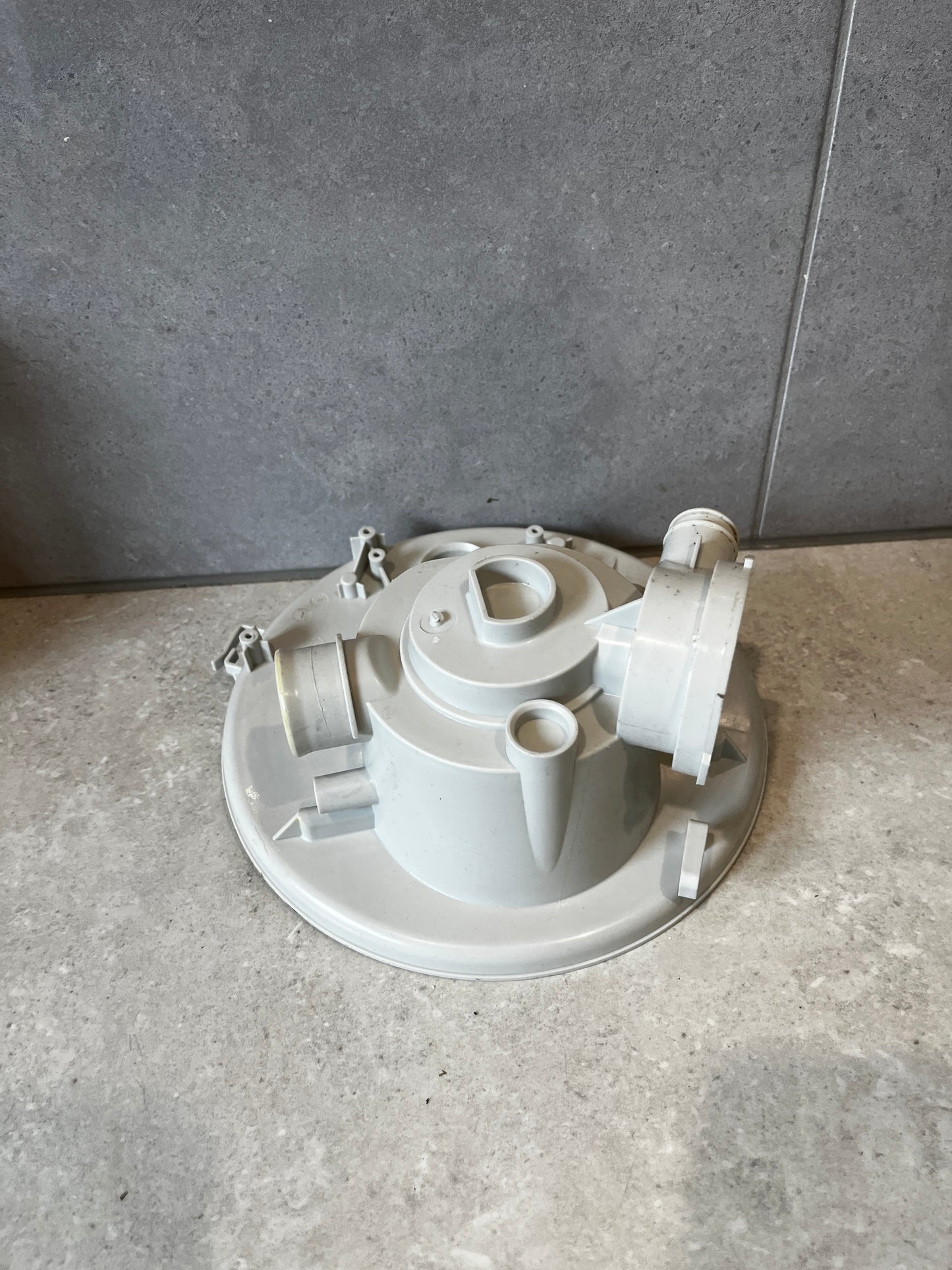 Side view of polypropylene pump filter housing showing multiple connection ports