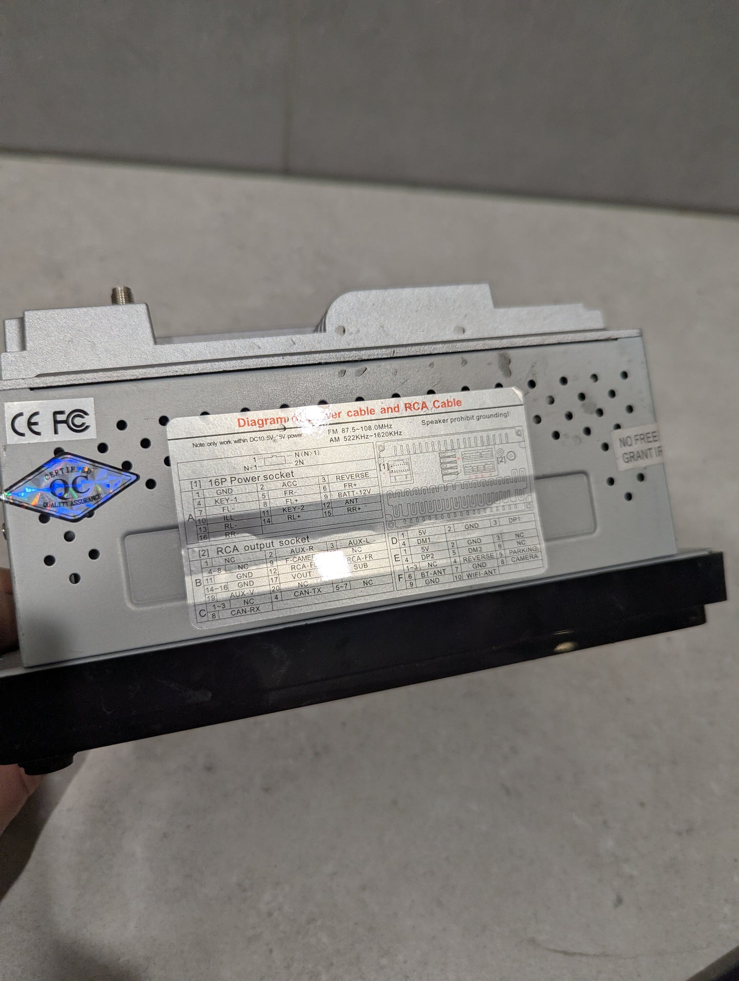 Close-up of car stereo head unit's wiring diagram and certification labels