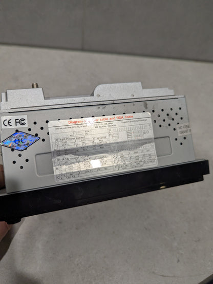 Close-up of car stereo head unit's wiring diagram and certification labels