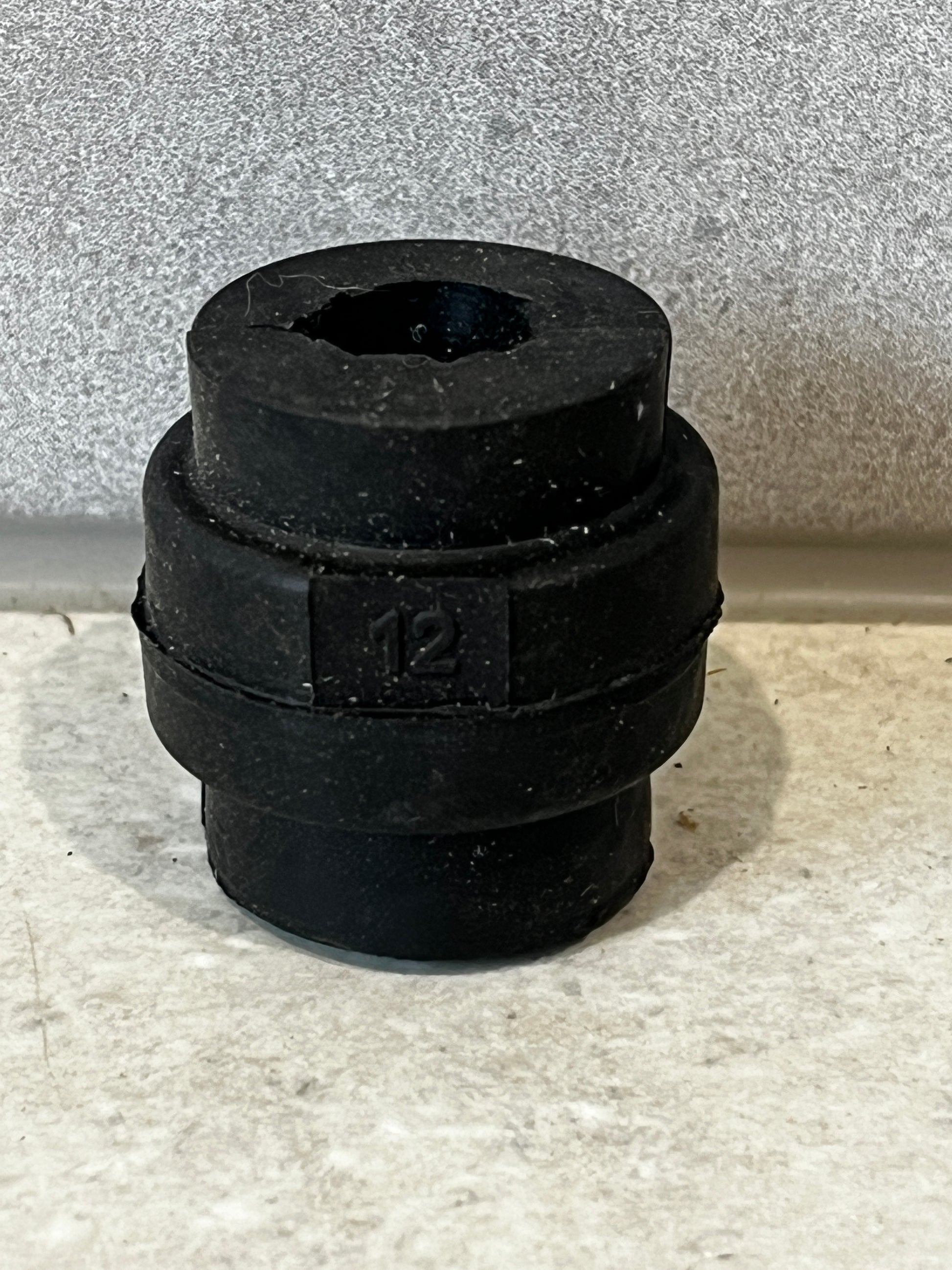 Bag of bulk black rubber grommets labeled 12mm
