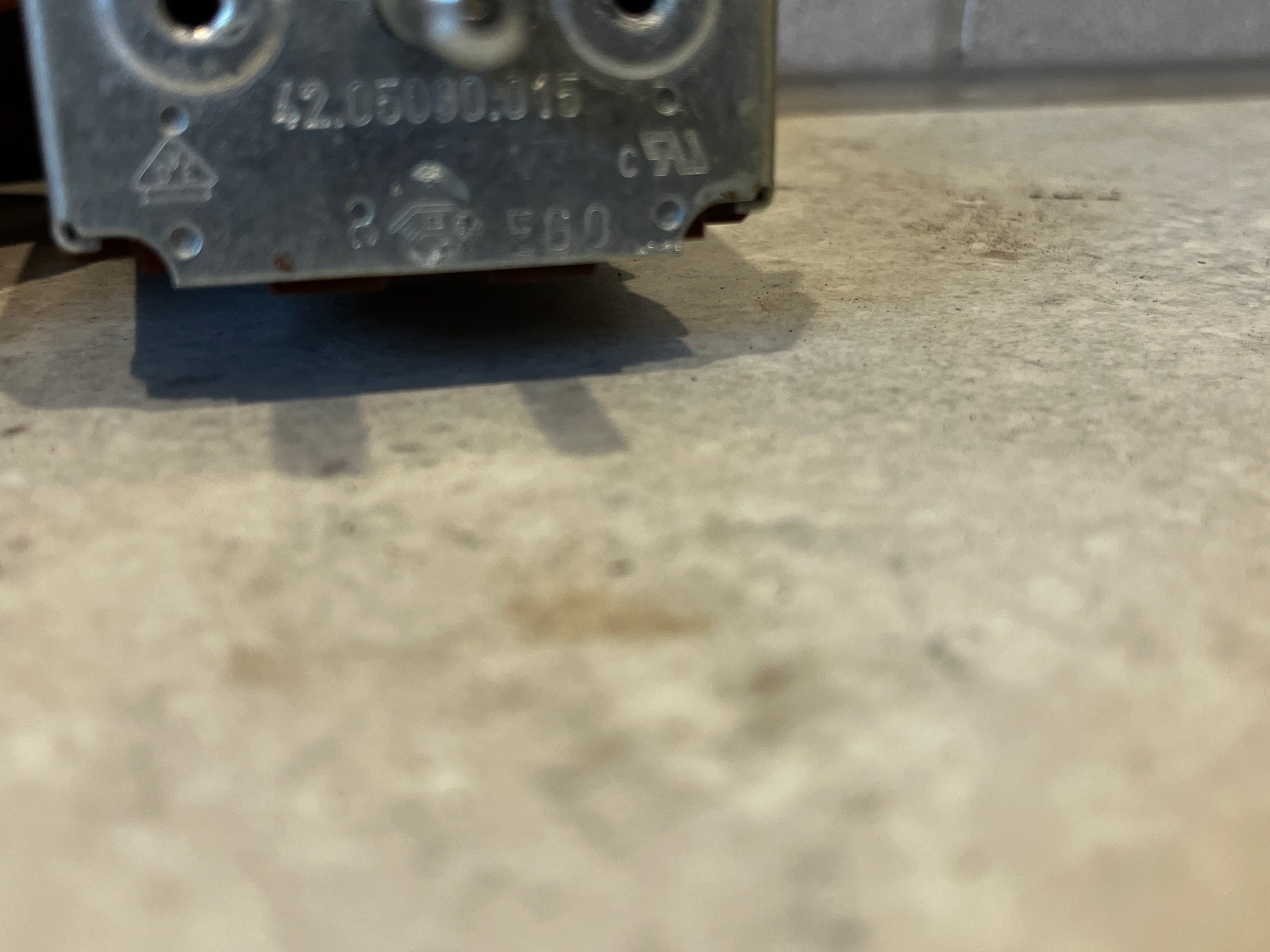 Close-up of rotary switch component showing engraved specifications and metal contacts
