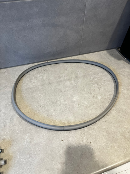 Flexible gray washing machine door seal gasket on countertop