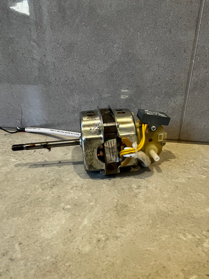 Side view of electric motor showing metal casing and wires on grey background