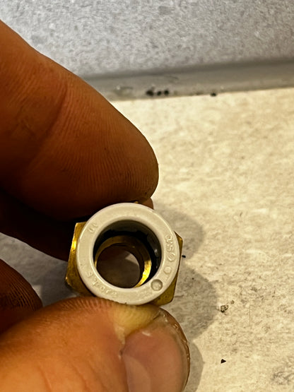 Front view of brass push-to-connect tube fitting showing internal collar
