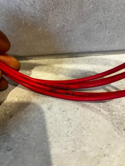 Close-up image showing red polyethylene tubing details and markings