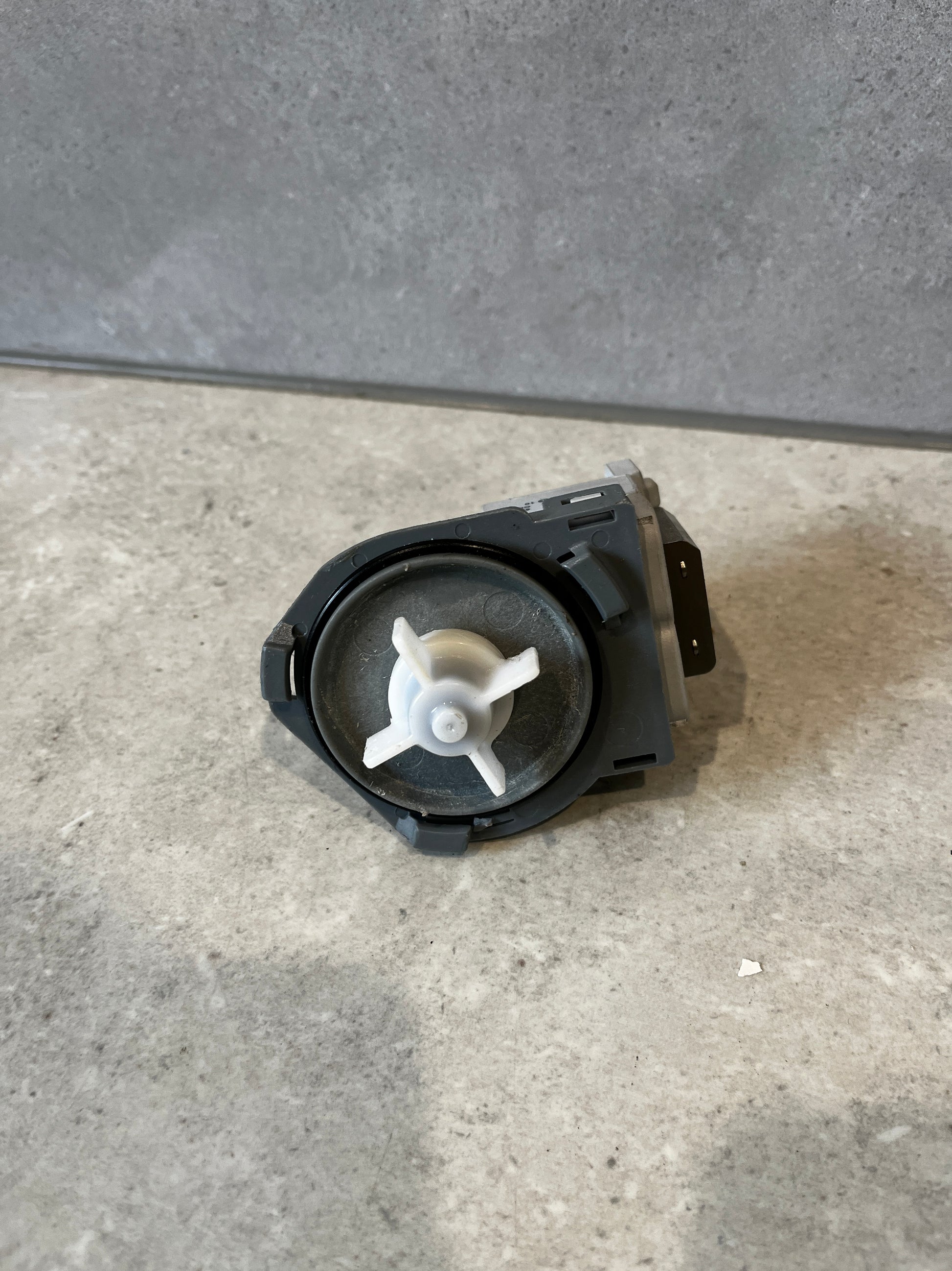 Impeller side view of washing machine drain pump motor replacement showing propeller detail