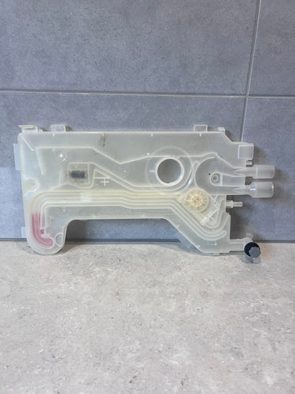 Reverse side of dishwasher water inlet valve assembly on tiled background