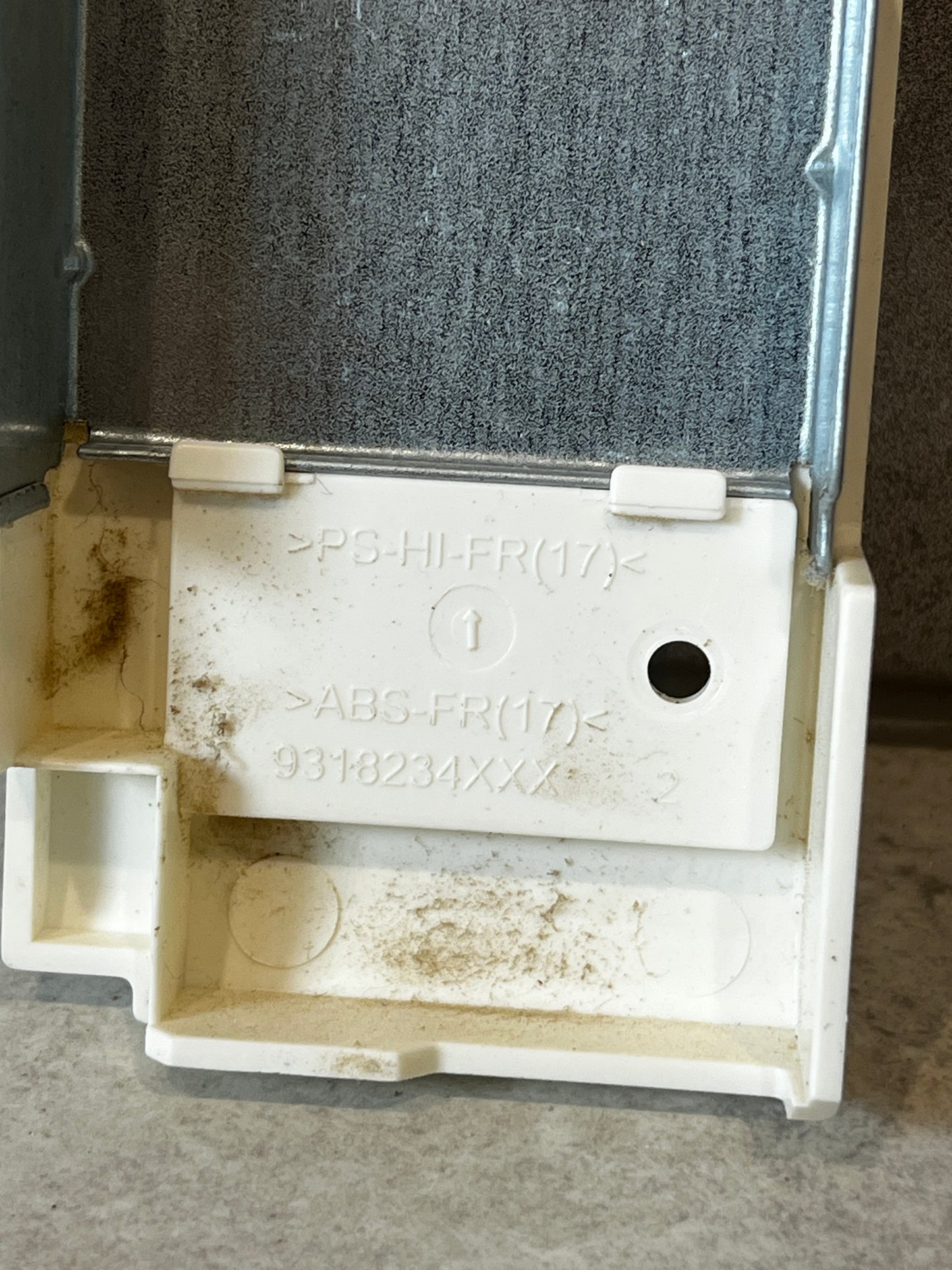 Inside close-up of the electrical enclosure junction box showing material markings and metal backing