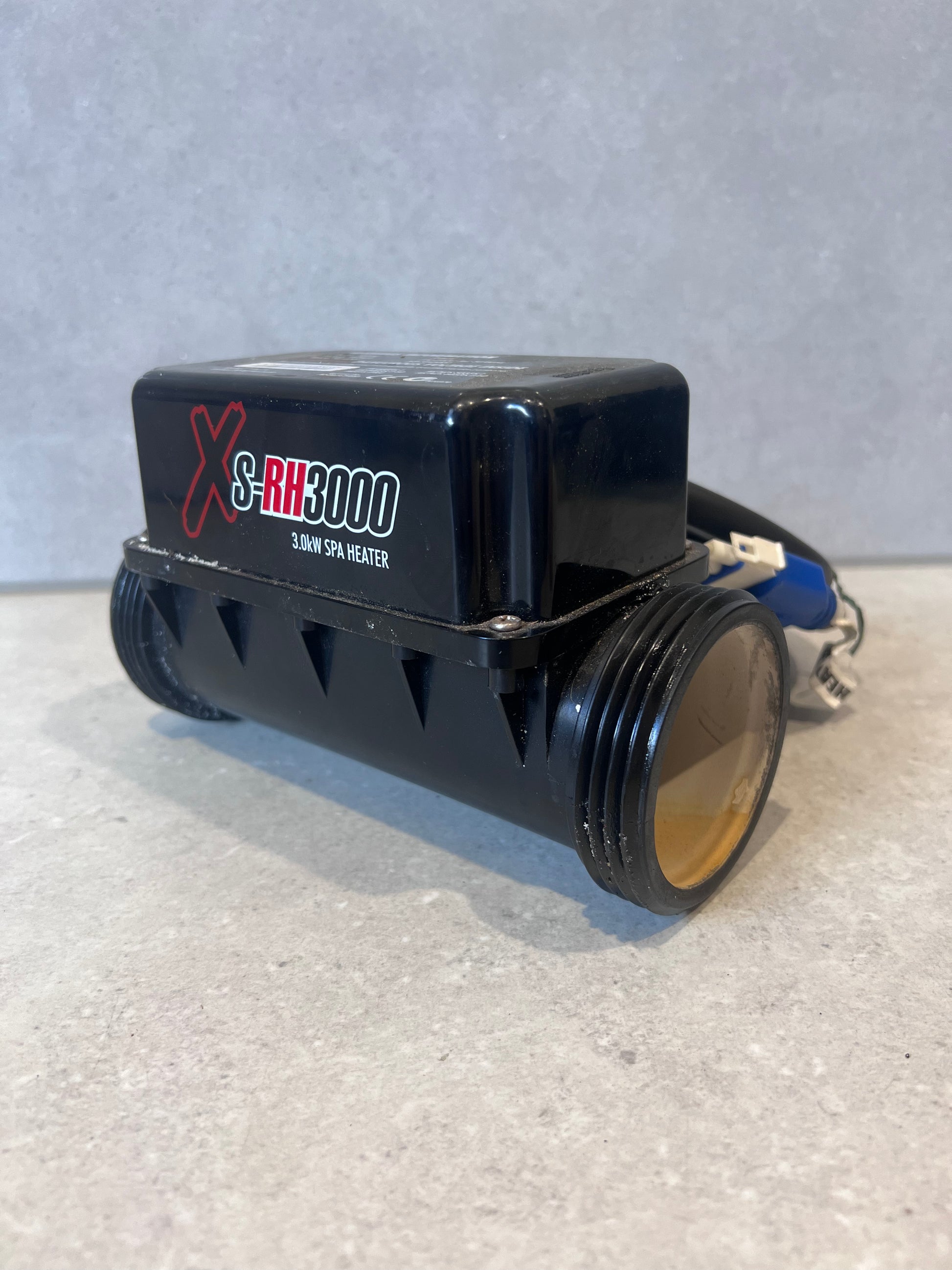 Side view of XS-RH3000 3.0kW spa heater showing product branding and connections