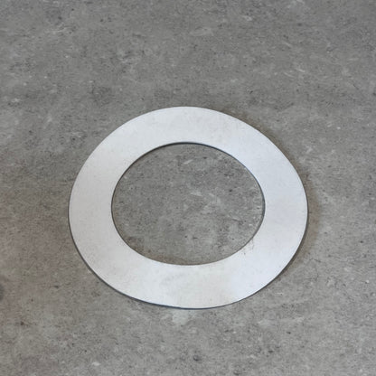 Single Garlock PTFE gasket on gray surface
