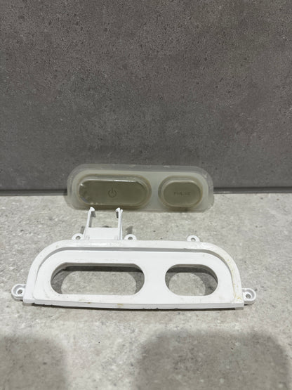 Close up of white blender control panel frame showing rectangular and oval cutouts for buttons