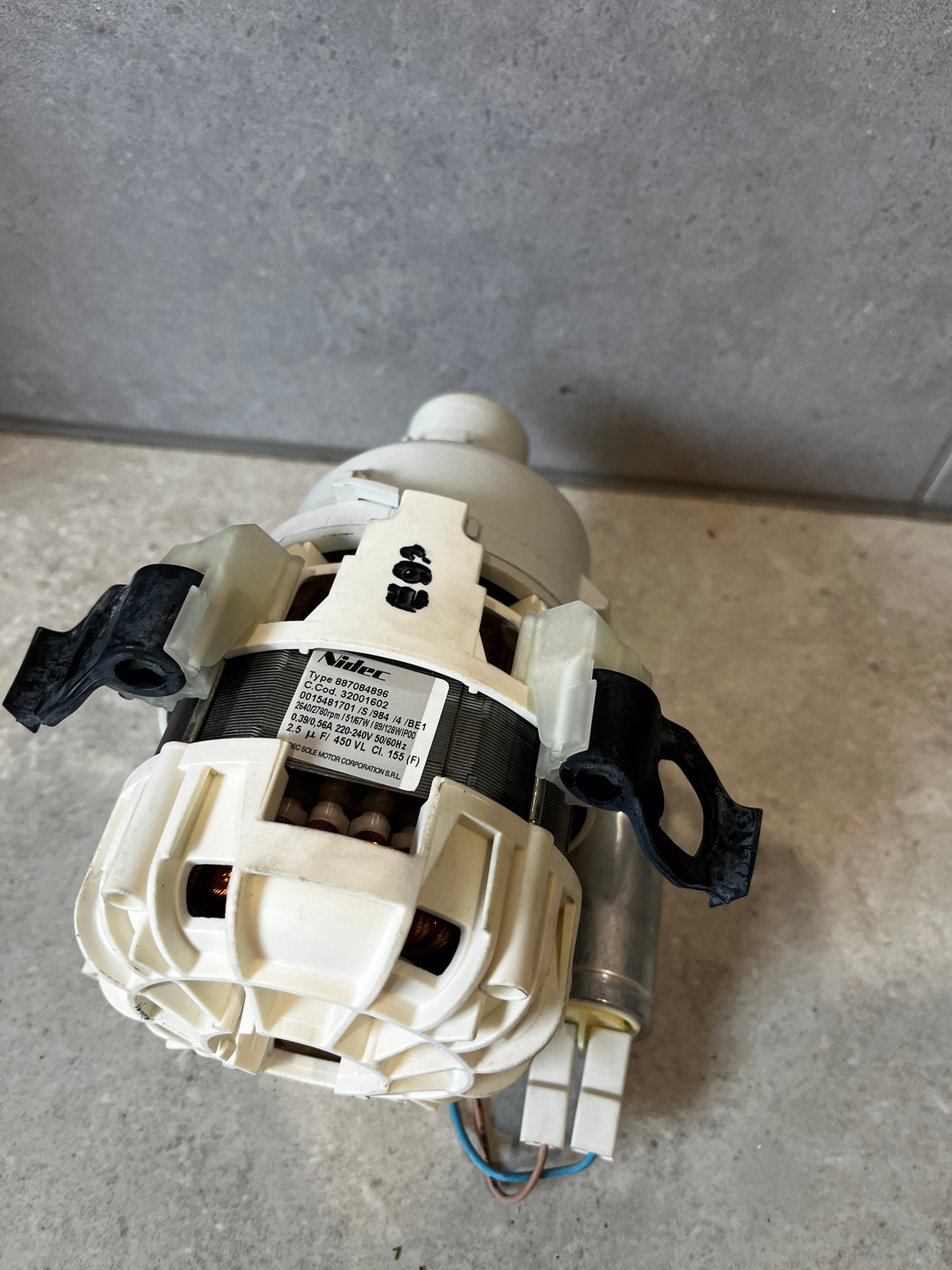 Label and wiring view of washing machine drain pump motor assembly