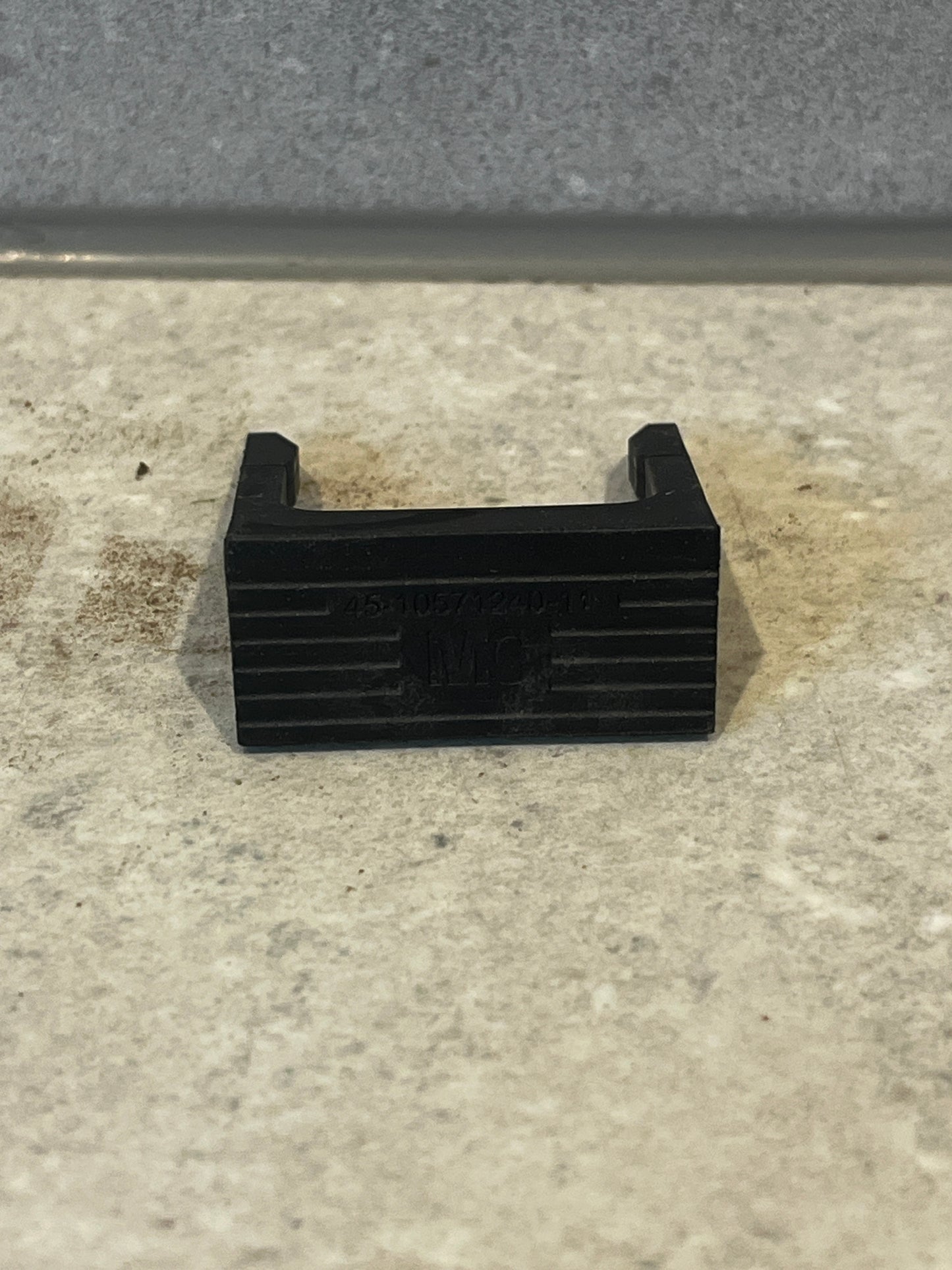 Front view of black U-shaped spacer block showing opening