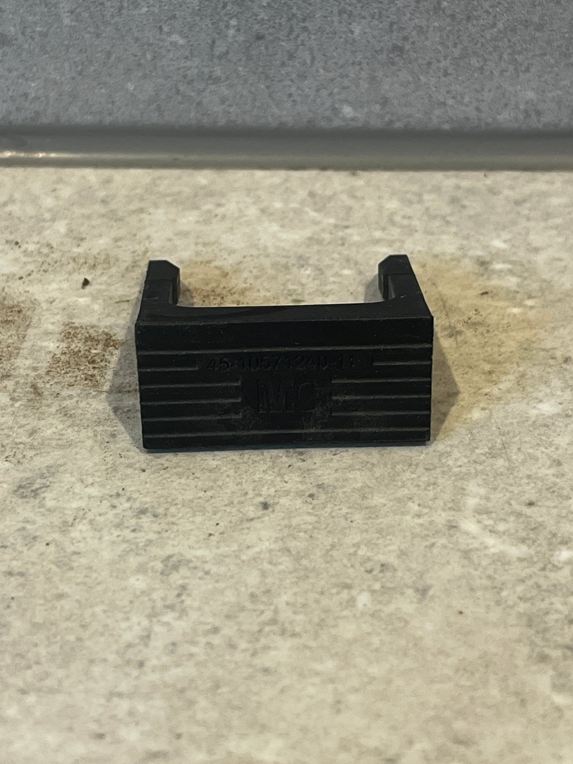 Front view of black U-shaped spacer block showing opening