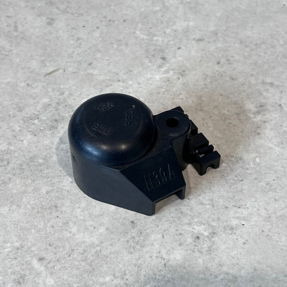 Black plastic CWH17039A terminal cover viewed from above on a gray surface