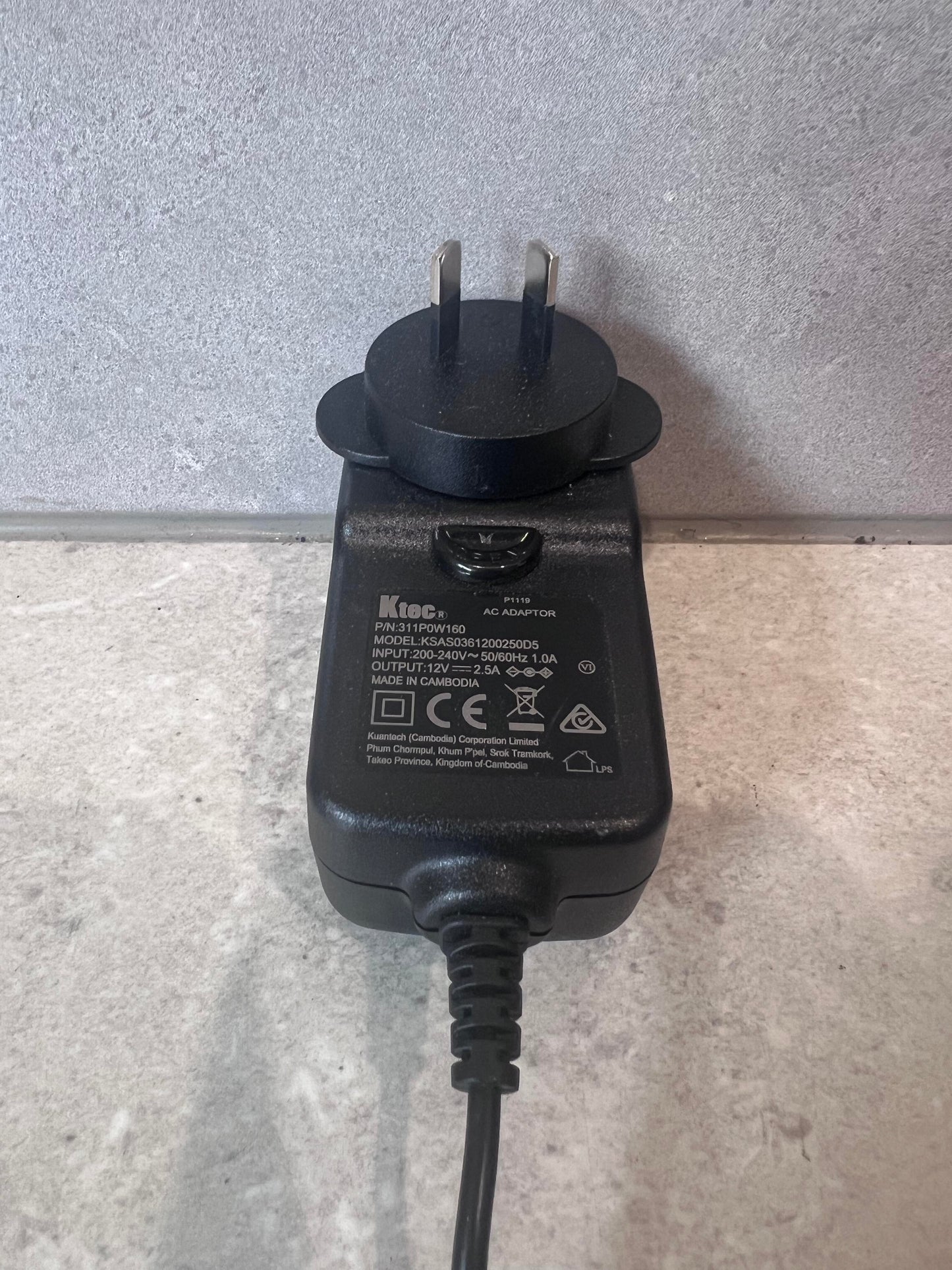 Close-up of front and plug of Ktec AC power adapter showing label and specifications