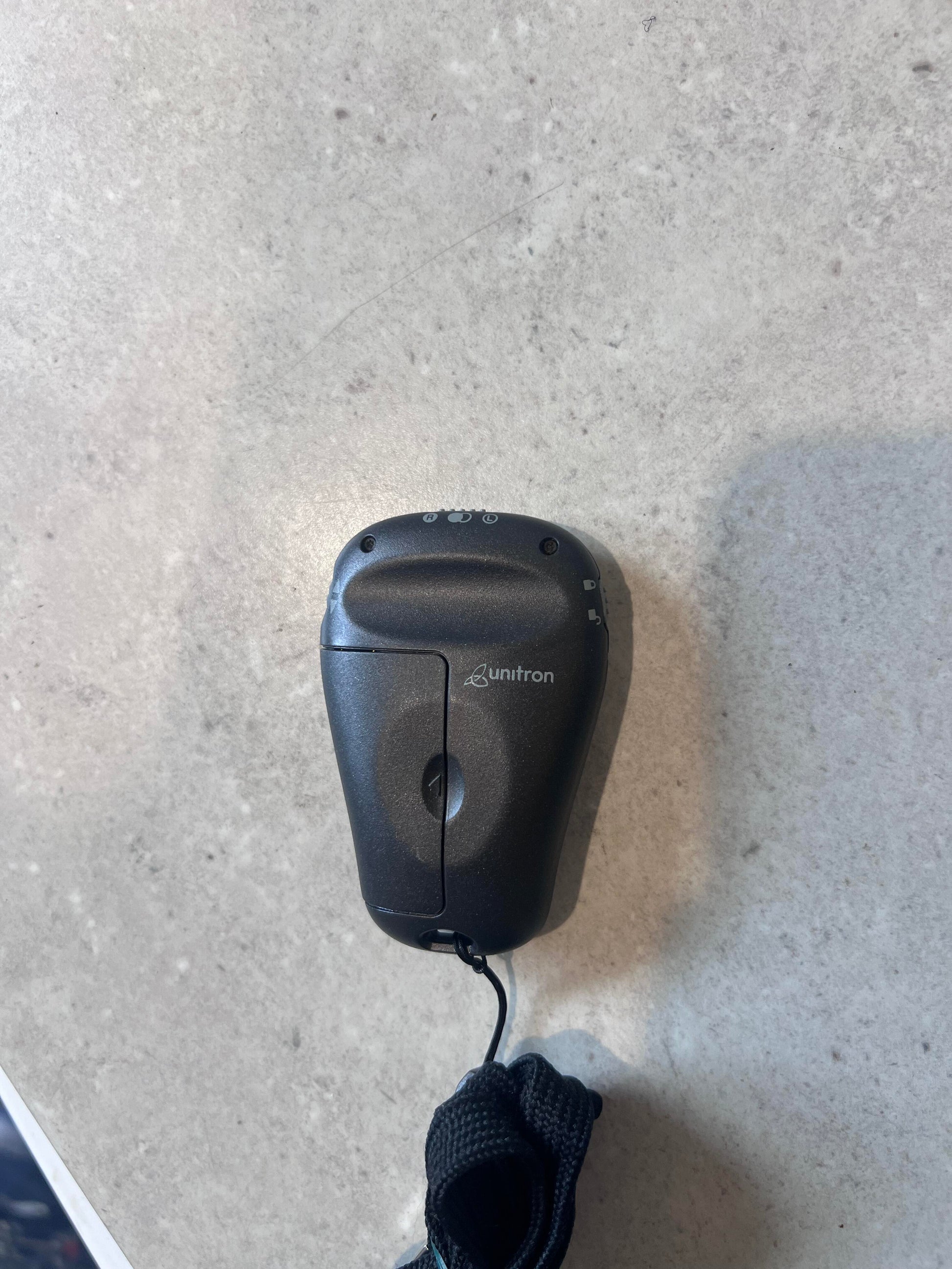 Unitron Smart Control Remote with lanyard, back view showing brand logo