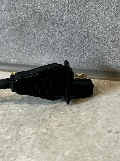 Close-up of automotive power adapter harness connector showing detail and metal contact