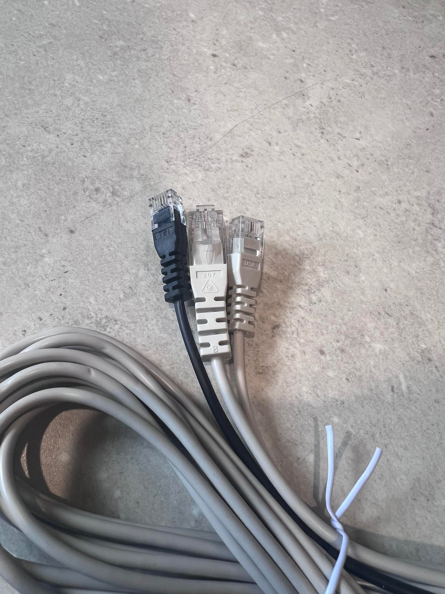 Close-up of Ethernet patch cable ends with black and gray connectors