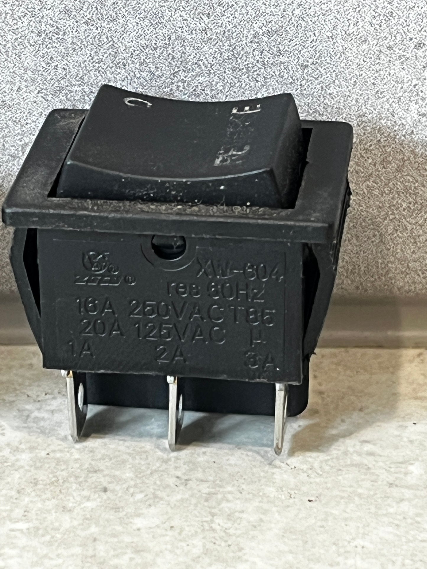 Close-up of heavy duty rocker switch displaying electrical ratings and terminals