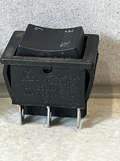 Close-up of heavy duty rocker switch displaying electrical ratings and terminals