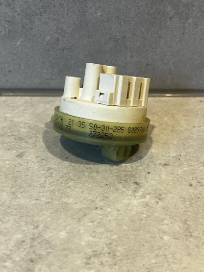 Side angle showing connectors and printed codes on washing machine pressure switch