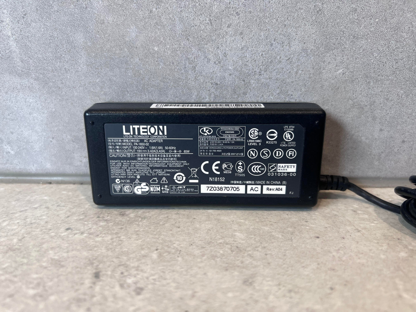 Close-up of LiteOn PA-1650-02 laptop power adapter label
