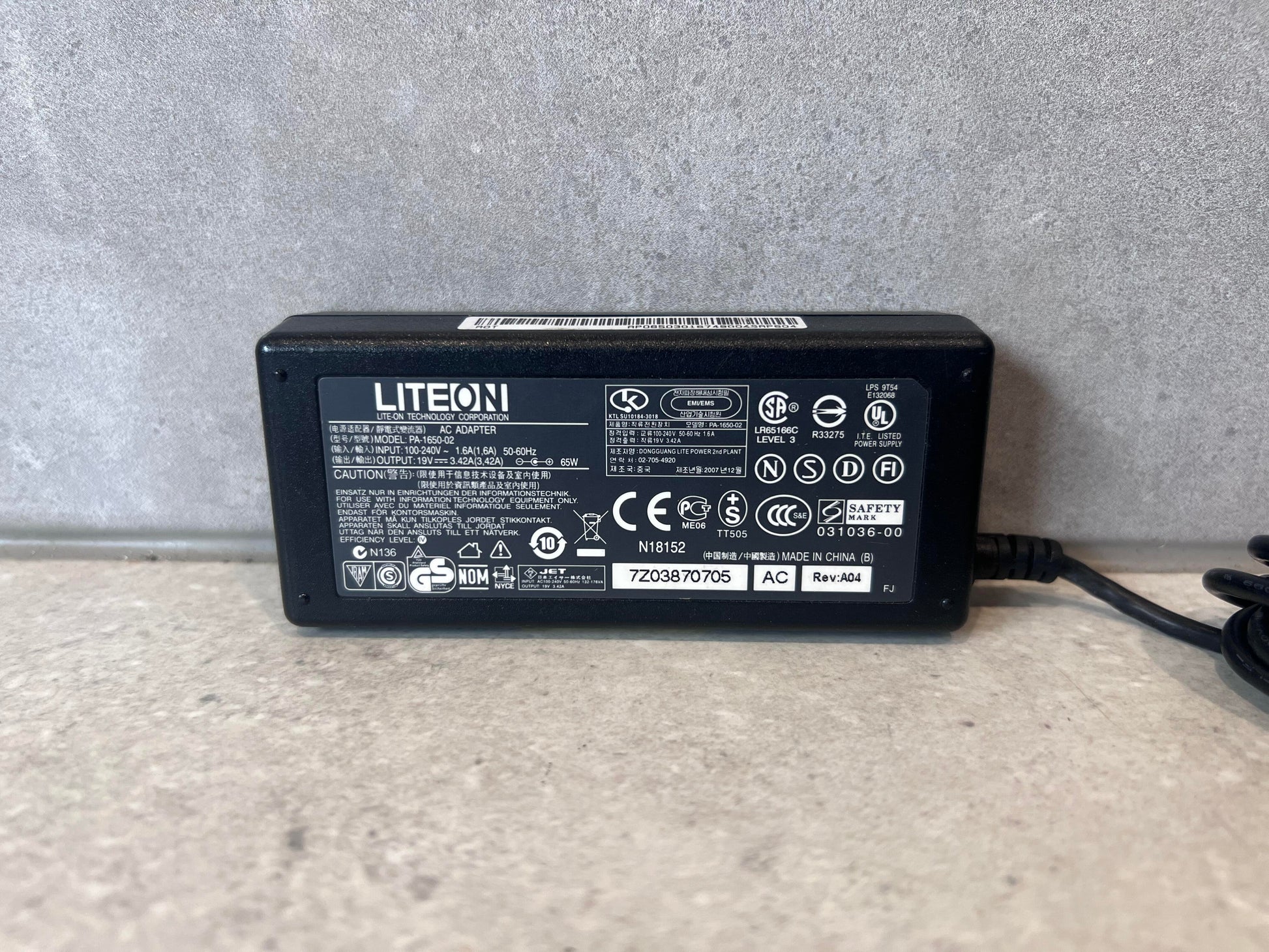 Close-up of LiteOn PA-1650-02 laptop power adapter label