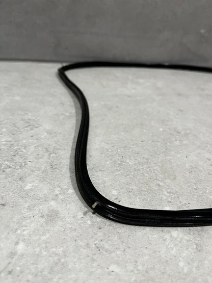 Close-up of black rubber window seal gasket corner showing texture and sealing grooves